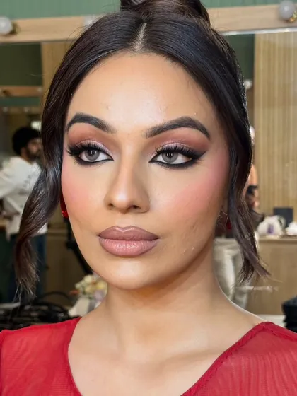 A three-quarter view of this unfiltered glam makeup, showcasing the sharp smoked liner and flawless cheek blending.