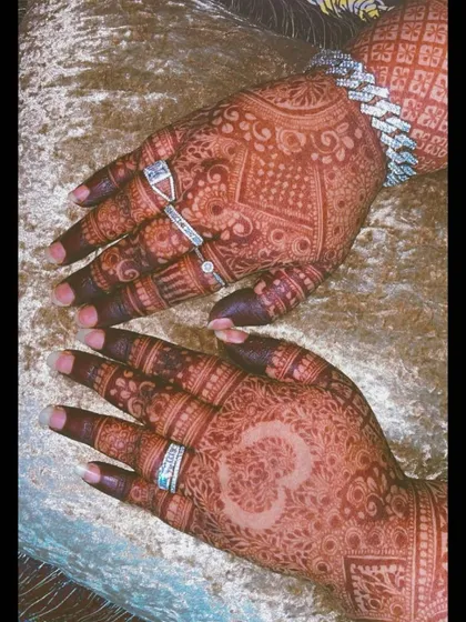 A view of both hands, one with a heart and one with an Om symbol, showing how you can mix and match personal elements.
