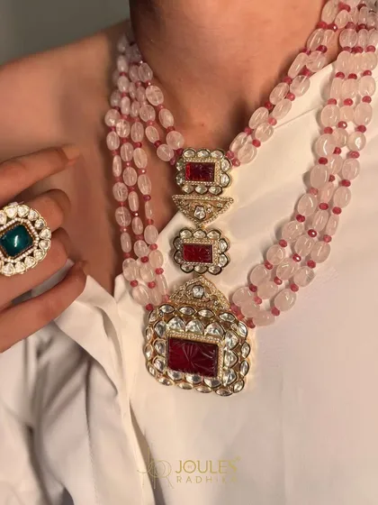Beauty in every bead. A multi-strand ruby bead necklace with a large, intricately carved pendant, perfect for adding a touch of color and grandeur to your ensemble.