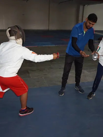 Personal attention makes all the difference. I am showing a student the correct way to hold his blade and position himself during a practice session. This one-on-one coaching is a core part of our camp, helping fencers fix mistakes and improve quickly.