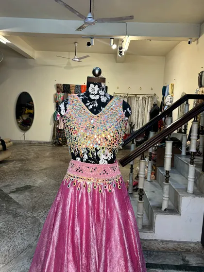 The blouse and skirt of the mirror work lehenga, showing the intricate details and craftsmanship.