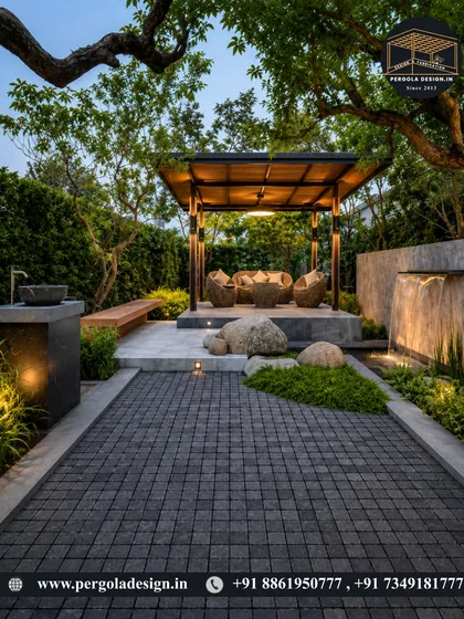 An evening view of a garden gazebo, where integrated lighting transforms the space into a magical retreat. Nestled among trees and alongside a water feature, it’s the perfect spot for unwinding after a long day.