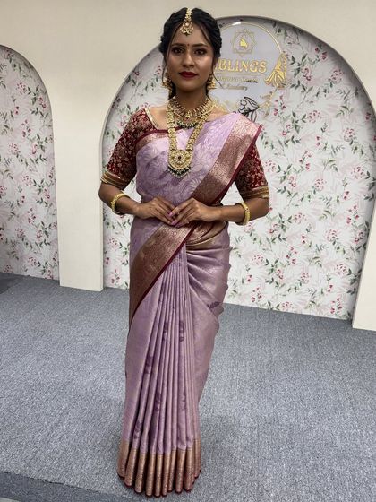 A full-length view of a model in a lavender silk saree. This showcases how the 'Fluffy Pleats' create a beautiful, flowing silhouette that is perfect for any formal event.