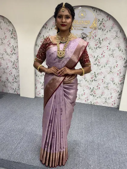A full-length view of a model in a lavender silk saree. This showcases how the 'Fluffy Pleats' create a beautiful, flowing silhouette that is perfect for any formal event.