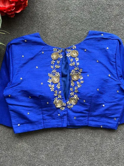 A full view of the back of the royal blue handwork blouse, showcasing the detailed embroidery.