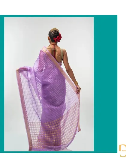 Showing the back of the African Violet organza saree, this view emphasizes the sheer texture and the rich detail of the gold zari work in the pallu.