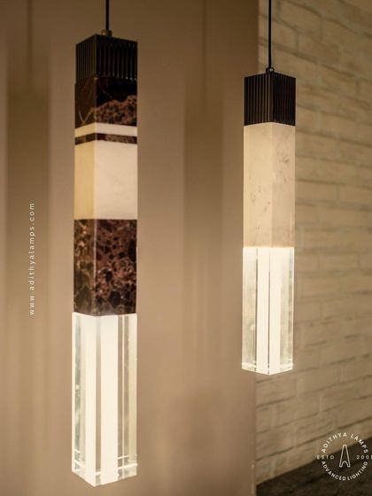 A collection of our pillar pendants, which combine sections of solid marble, fluted metal, and clear crystal. These substantial, high-quality fixtures can be hung individually or in clusters to create a dramatic effect in stairwells or entryways.