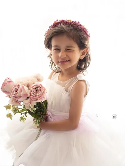 It's the unposed, spontaneous moments that are often the most memorable. This cheeky wink perfectly captures her playful personality during a simple and bright studio session.