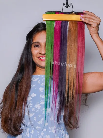 A client playfully peeks through a rainbow of our color bands. It shows the variety of fun and vibrant options available to express your personality.