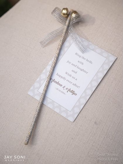 A sweet, personalized detail for the guests. This bell, with a note from the couple, was a charming touch that made the ivory wedding feel even more special.
