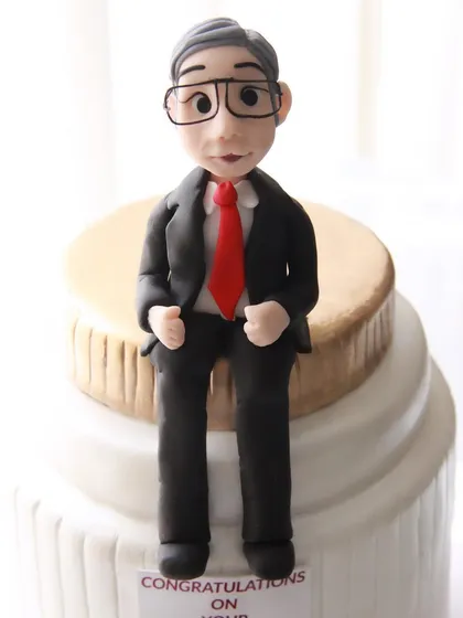 A close-up of the handcrafted figurine of the CEO, created to personalize his special birthday cake.