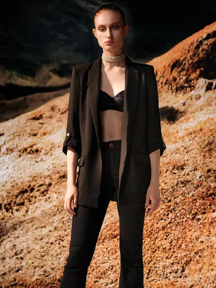 Similar to the previous shot, this image shows a different styling against a projected terrain. It emphasizes how the same lighting and background can be used to tell different fashion stories.