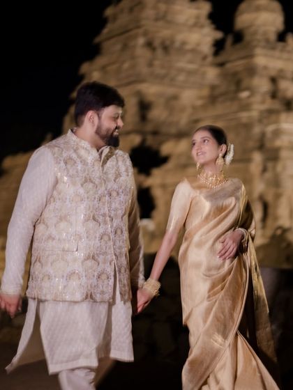Walking hand-in-hand into their future, with history as their witness. This shot at Mahabalipuram combines cultural grandeur with a simple, romantic gesture.