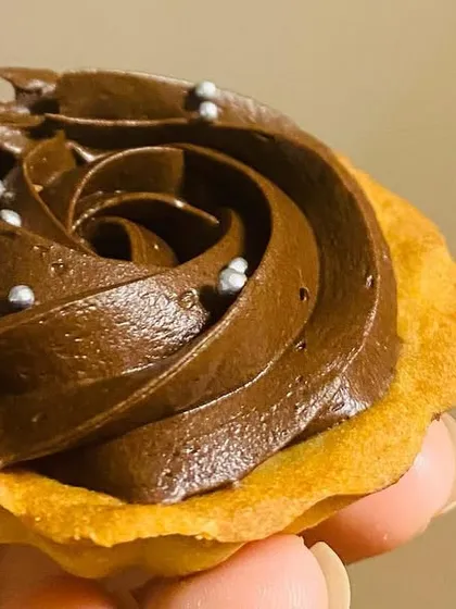A close-up of my Choco-Caramel Tart. It has a buttery tart shell filled with a smooth layer of caramel and rich chocolate, finished with a sprinkle of silver pearls.