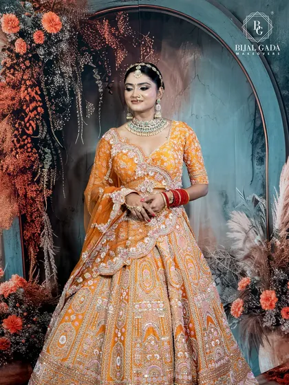 A full-length shot capturing the bride's complete look. The way the dupatta is draped and the lehenga flows creates a look of effortless grace and grandeur.