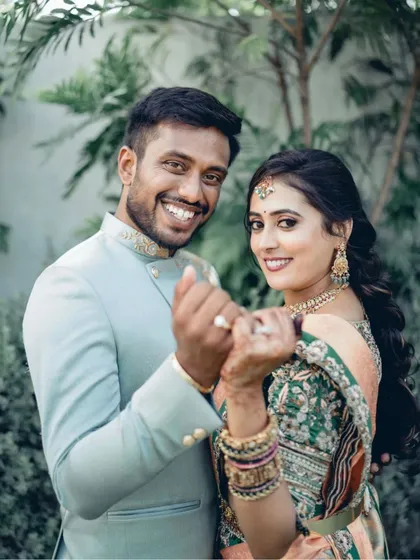 A fun and happy portrait of the newly engaged couple. Their bright smiles and playful pose, showing off their rings, are infectious.