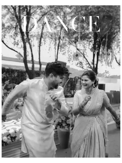 A black and white shot of the couple dancing, capturing the pure joy and energy of their Haldi celebration.