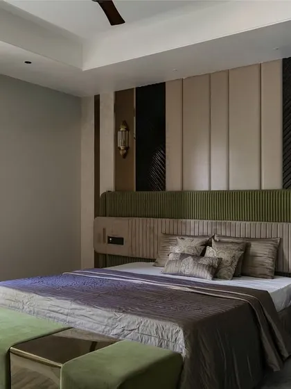 This bedroom carries a quiet strength, with its palette of muted olive green and taupe. Every panel, pleat, and polish was designed to slow the pace and invite rest.