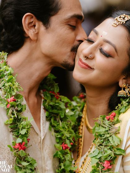 An intimate moment from a traditional Kerala wedding. The bride's kasavu saree, with its simple gold border, is the epitome of grace.