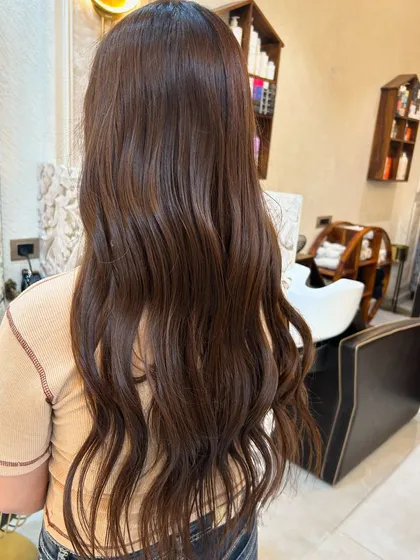 The back view of the long, wavy olive ashy brown hair. The colour is rich and multi-dimensional.