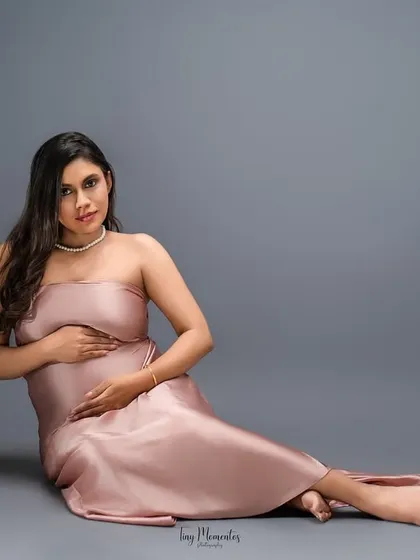 A graceful seated pose in the pink satin gown, this image has a quiet, classic glamour that is simply timeless.