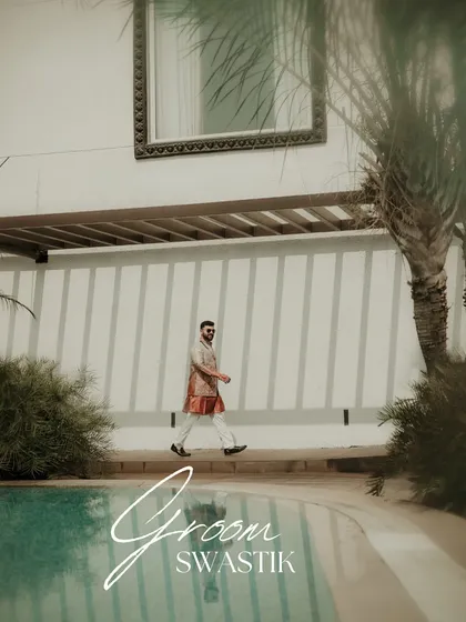 A cool and confident groom portrait. The text overlay adds a modern, editorial feel to this shot of the groom walking by the pool at his destination wedding.