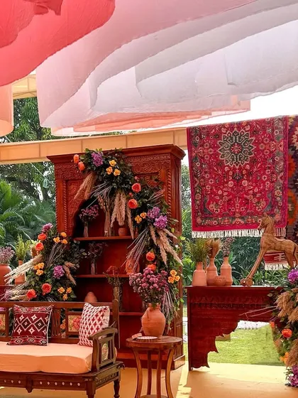 A closer look at the main seating area for the 'Souk Bazaar' theme, highlighting the carved wooden furniture, patterned cushions, and beautiful floral arrangements.