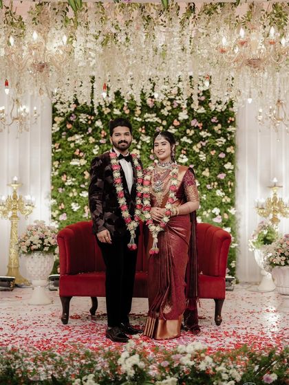 This bride's deep maroon saree for her reception is the definition of elegance. The draping style is sophisticated, with a focus on a clean pallu and perfectly falling pleats.