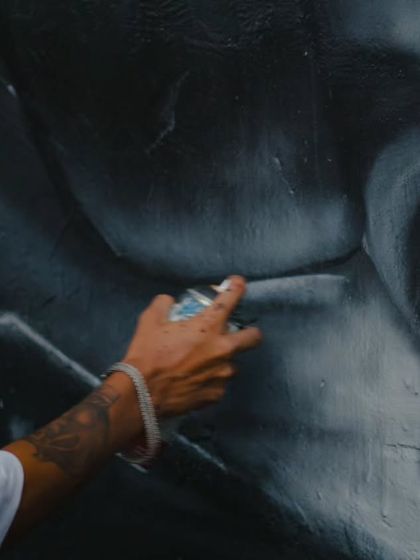 A shot of my hand, showing the spray can control needed to create the soft shades and gradients on the black and white portrait of Rohit Sharma.