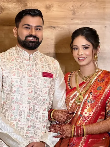 A traditional bridal bun for a Maharashtrian wedding ceremony. This style is designed to be both beautiful and sturdy enough to hold the saree's pallu and other jewels.