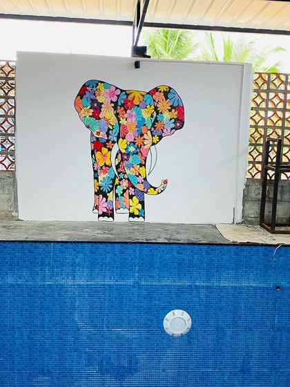 This floral elephant mural was painted on a wall right next to a swimming pool. The patience required to paint each and every flower was immense, but the colorful and joyful result was worth it.