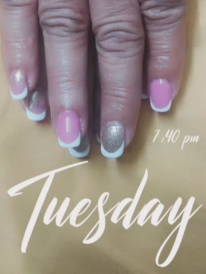 A playful mix of styles. This set combines pink nails, classic white French tips, and a full silver glitter accent nail.