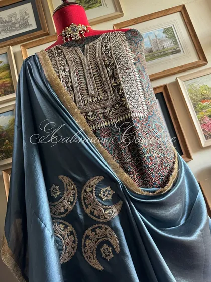 A styled view of the complete ensemble, showing the rich interplay between the printed modal silk kurta, the heavily embroidered yoke, and the elegant drape of the organza dupatta.