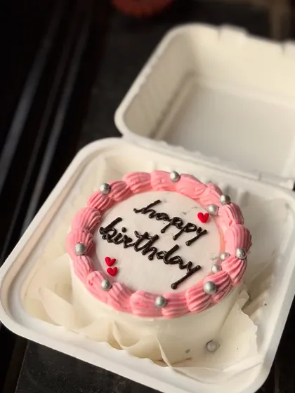 A pretty pink and silver birthday bento cake. The combination of piped swirls and silver pearls gives it a classic look.