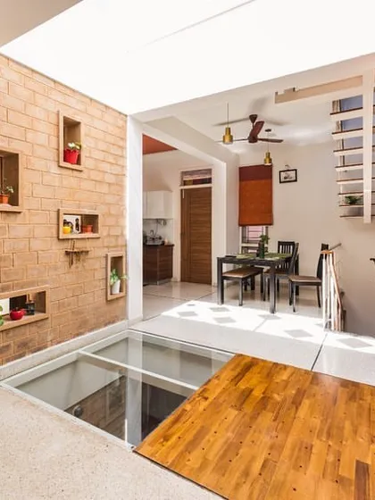On a compact city plot, we designed this home around a central skylight and a glass bridge. This solution floods both floors with natural light, creating a feeling of spaciousness and connection between the levels, proving that small sites can still feel grand.