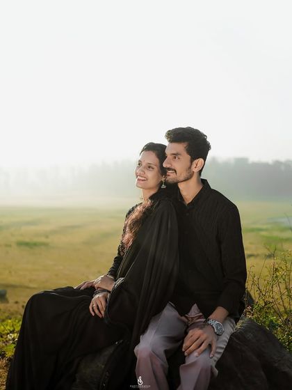 Looking out at the view together. This shot captures a shared moment of peace against a beautiful, hazy landscape.