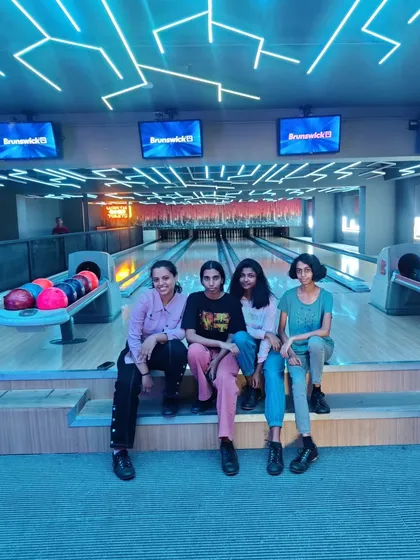 A group of girls sitting at our bowling alley, ready to play.
