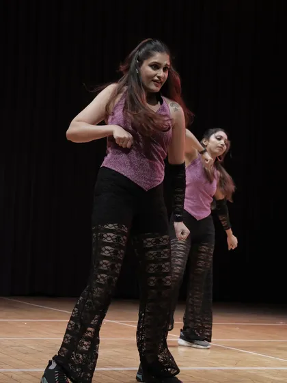 A dynamic group shot of the 'Sassy Girls' in action. Our choreography for adult batches is modern, fun, and designed to make everyone look and feel great.