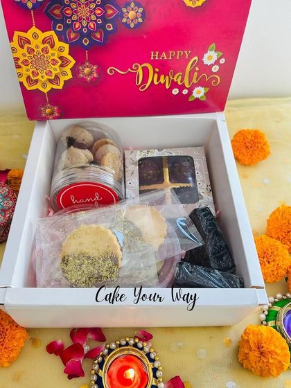 The "Zayka Diwali Box" is a perfect mix of sweet and savory. It contains Oreo Mini Cookies, Pistachio Sable, Italian Pizza Sticks, a Fudgy Brownie, and my Date & Chocolate Foxnut Laddoos.