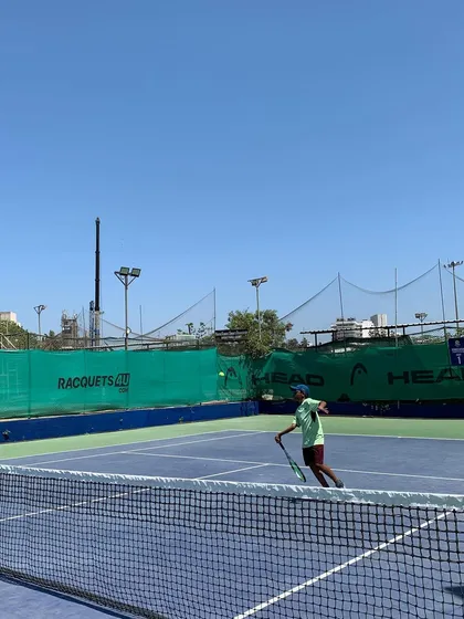 A player mid-swing, demonstrating focus and form during the TenniStation Season 12 tournament.