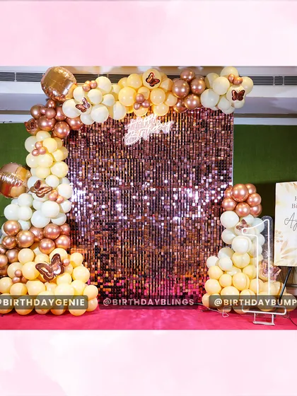 This elegant butterfly-themed party features a stunning rose gold shimmer wall that creates a perfect photo backdrop. I complemented it with a sophisticated balloon arch in cream and metallic tones and a personalized welcome sign for a chic and memorable celebration.