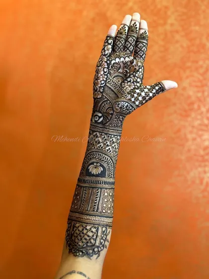 A single arm from a full bridal design. This showcases the intricate patterns and the flow of the design from the hand to the upper arm.