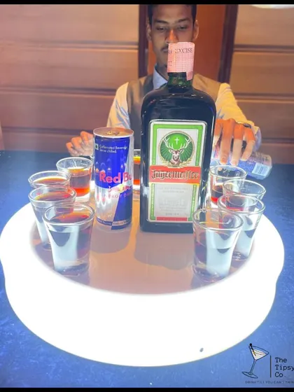 A tray of Jagerbombs being prepared. The glowing tray and the iconic combination of Jagermeister and Red Bull make this a guaranteed party-starter.