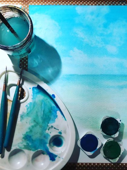 On days when I can't be by the sea, I invite the ocean to my desk. This is my watercolor setup, with a simple seascape in progress, surrounded by my favorite shades of blue.