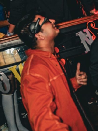 In my element during a Halloween set. The orange jacket was part of the costume, but the energy was 100% real.
