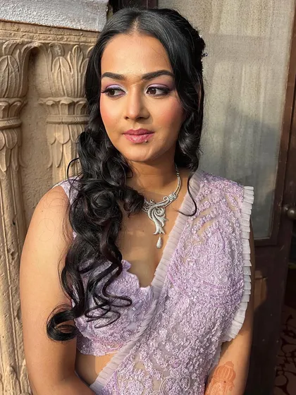 The beautiful lavender saree and soft makeup create a dreamy look for this outdoor engagement. The natural lighting highlights her radiant skin perfectly.