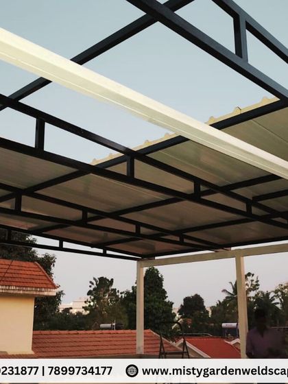 The completed puff sheet pergola at Skylark Villa in Whitefield. The combination of the insulated roof and the black and white frame creates a modern and comfortable outdoor lounge area.