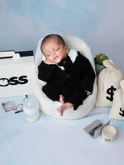 Presenting our little boss baby. Surrounded by his briefcase and bags of money, this little guy is already running the show.