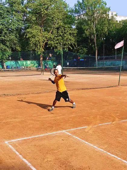 A junior player executing a powerful forehand during a practice match. We encourage our players to be aggressive and dictate points.