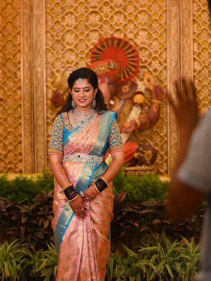 A candid moment during the reception photoshoot. The makeup looks beautiful under the professional lighting.